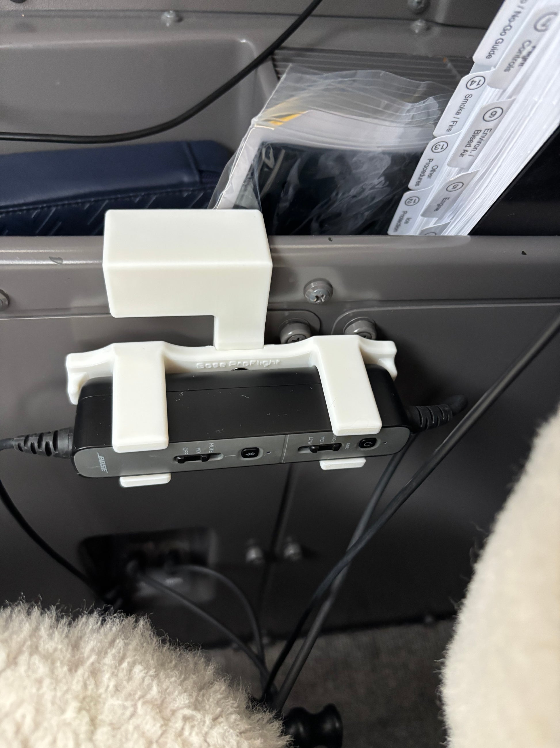 Bose ProFlight headset control mount installed in a Bombardier corporate jet cockpit sidewall